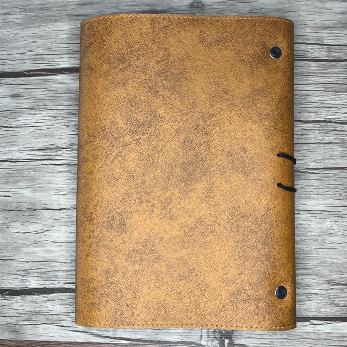 Dos du carnet de voyage en cuir camel